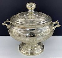 Overall view of lidded silver-plated tureen showing handles, lid, pedestal base and inscription