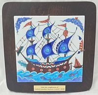 Frontal view of tile mounted on wood plaque