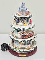 Full view of multi-tier Disney Christmas tree sculpture on base with power cord