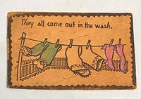 Front of leather postcard showing clothesline illustration and text