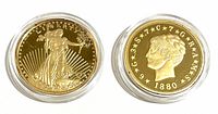 Obverse sides of both gold-clad replica coins in capsules