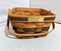 Front view showing brass Longaberger JW Collection 1990 Edition plaque and swing handle