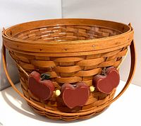 Exterior view showing basket shape, swing handle and apple ornaments