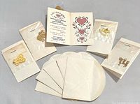 All five Lil' Charms cards laid out with envelopes and charms visible