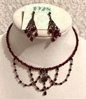 Choker displayed on bust with earrings on 1928 card