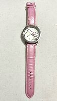 Front view of Hello Kitty wristwatch, pink strap extended
