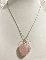 Full view of necklace on display bust showing pendant and chain