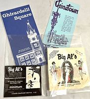 Front view showing all four items: Ghirardelli Square brochure, Chinatown brochure, Big Al's tent card, Big Al's napkins