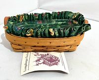 Overall view of basket with liner, protector and brochure