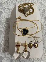 Entire set of two necklaces and two pairs of earrings displayed