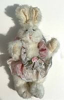 Front view of white plush bunny in pastel dress