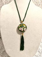 Full necklace on bust showing pendant and tassel