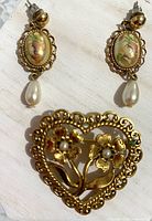 front view of earrings and brooch