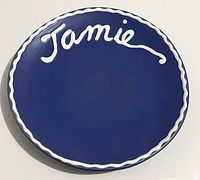 Front view showing blue glaze, white "Jamie" script and border