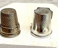 Front view of both thimbles showing finishes and textures