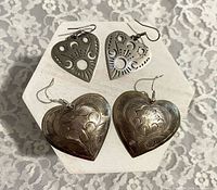 Front view of both earring pairs on hexagonal stand