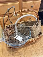 Multiple nested baskets including large wicker, metal banana hook basket, seagrass square basket, white wicker