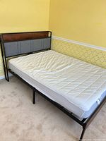 Full view of assembled twin bed frame with mattress in room