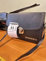 Bushnell logo case closed, clasp visible