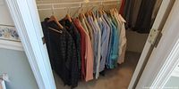 Closet rod with all shirts hanging on wooden hangers