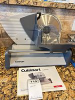 Full view of Cuisinart slicer with manual on counter