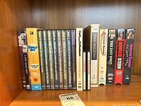 Full shelf showing all DVDs and VHS tapes in lot