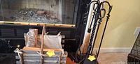 Overall view showing fireplace tool set and log holder in front of fireplace