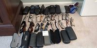 Overview of all eyeglasses, sunglasses and cases on floor