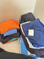 Stacked piles of shirts and shorts showing variety and quantity
