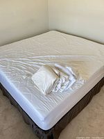 full view of bedframe with mattress and sheets