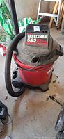 Full view of Craftsman wet/dry vac with hose attached, showing body condition