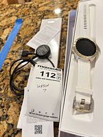 Watch in tray with strap, charger, paperwork