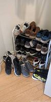 Sneakers arranged on rack and on floor