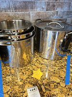 Large stock pot and nested stainless pots on countertop
