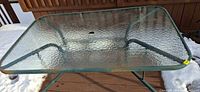 Top view of rectangular glass table with umbrella hole