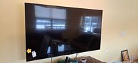 Front view of TCL 75-inch TV mounted on wall