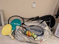 Overall view of bag, racquet, paddles, covers and balls