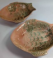 Top view of both fish-shaped bowls showing glaze colors and condition