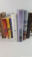 Group shot of eight books standing upright showing spines