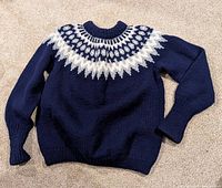 Full view of sweater laid flat showing entire garment