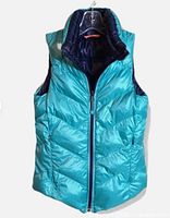 Front view showing teal color, chevron quilting, full zipper