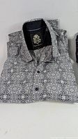 Front view of folded English Laundry patterned shirt