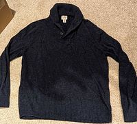 Full view of dark navy shawl-collar sweater laid flat