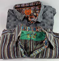 Two folded shirts showing exterior patterns and inner collar details