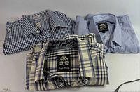 Three folded shirts showing patterns and collars