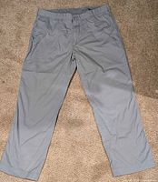 Full front view of pale blue chinos laid flat