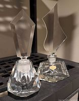 Two faceted crystal perfume bottles with stoppers inserted