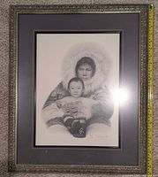 full view of framed charcoal print with ruler for scale