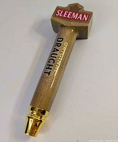 Full view of Sleeman Original Draught wooden tap handle showing logo topper and ferrule