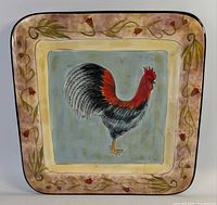 Front view of square rooster platter showing design and border
